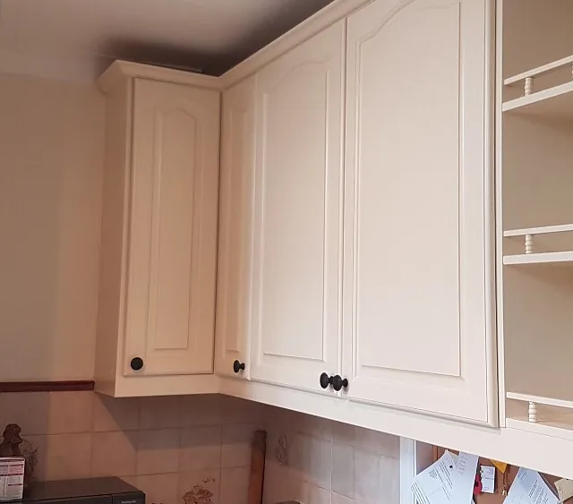 white painted cupboards and clock